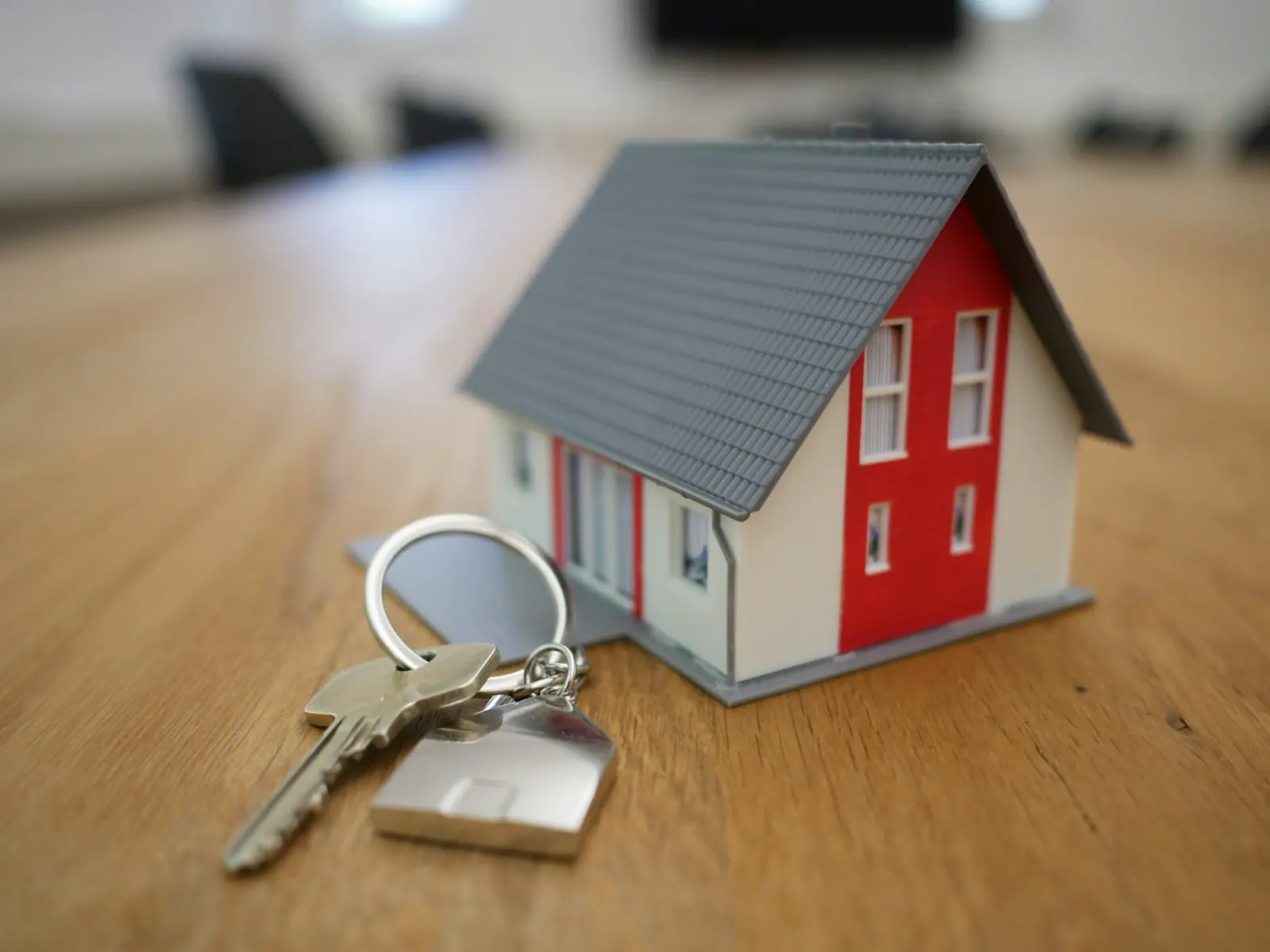 Model home and keys representing a property transaction