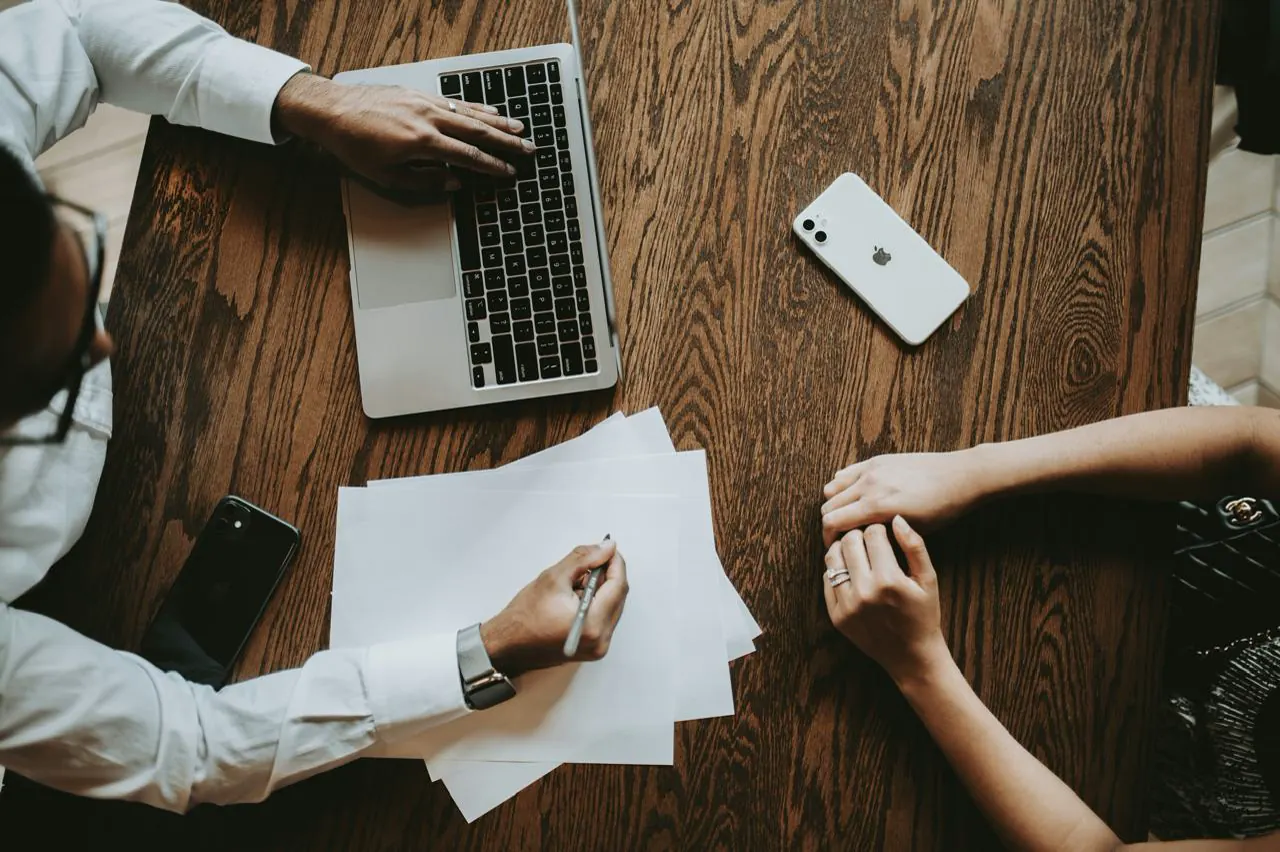 Legal professionals reviewing documents with a client