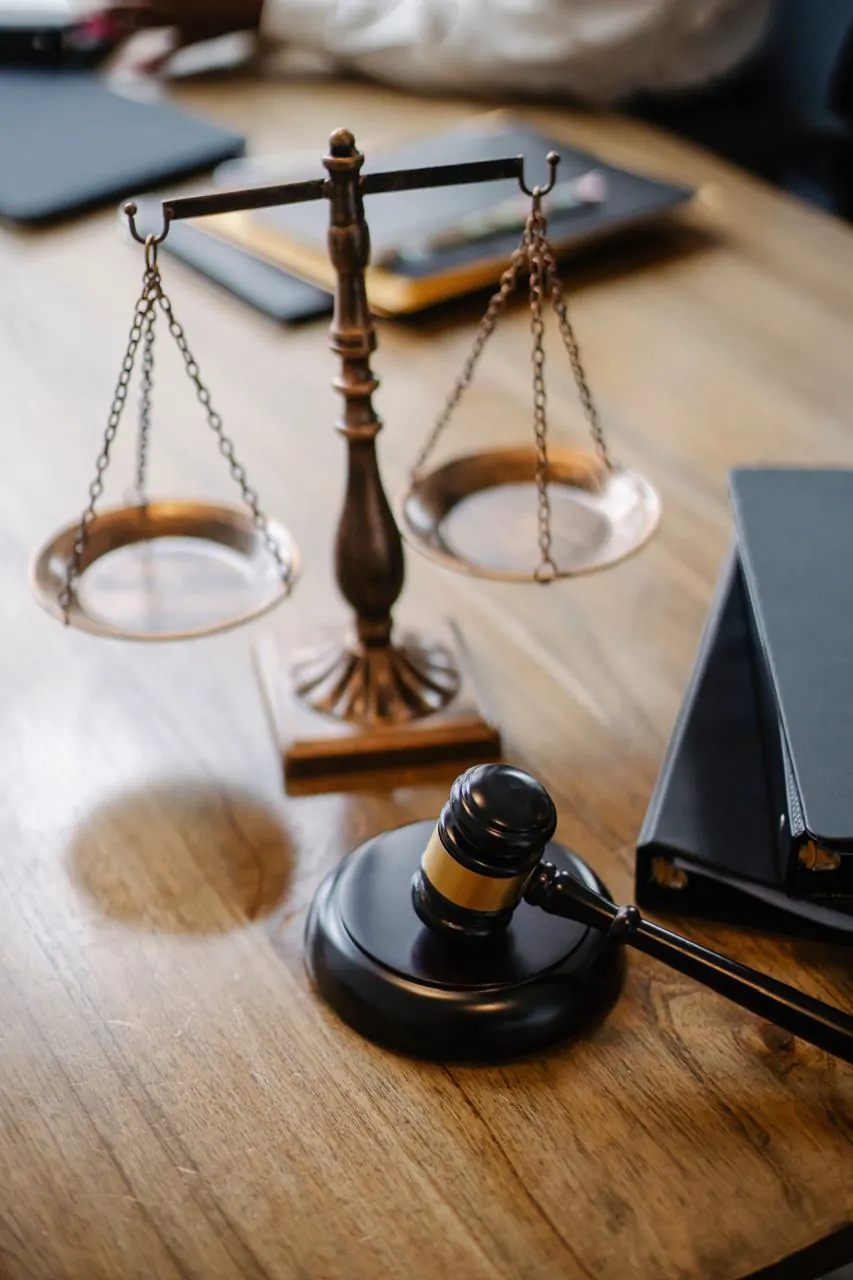 Scales of justice and a legal gavel on a desk